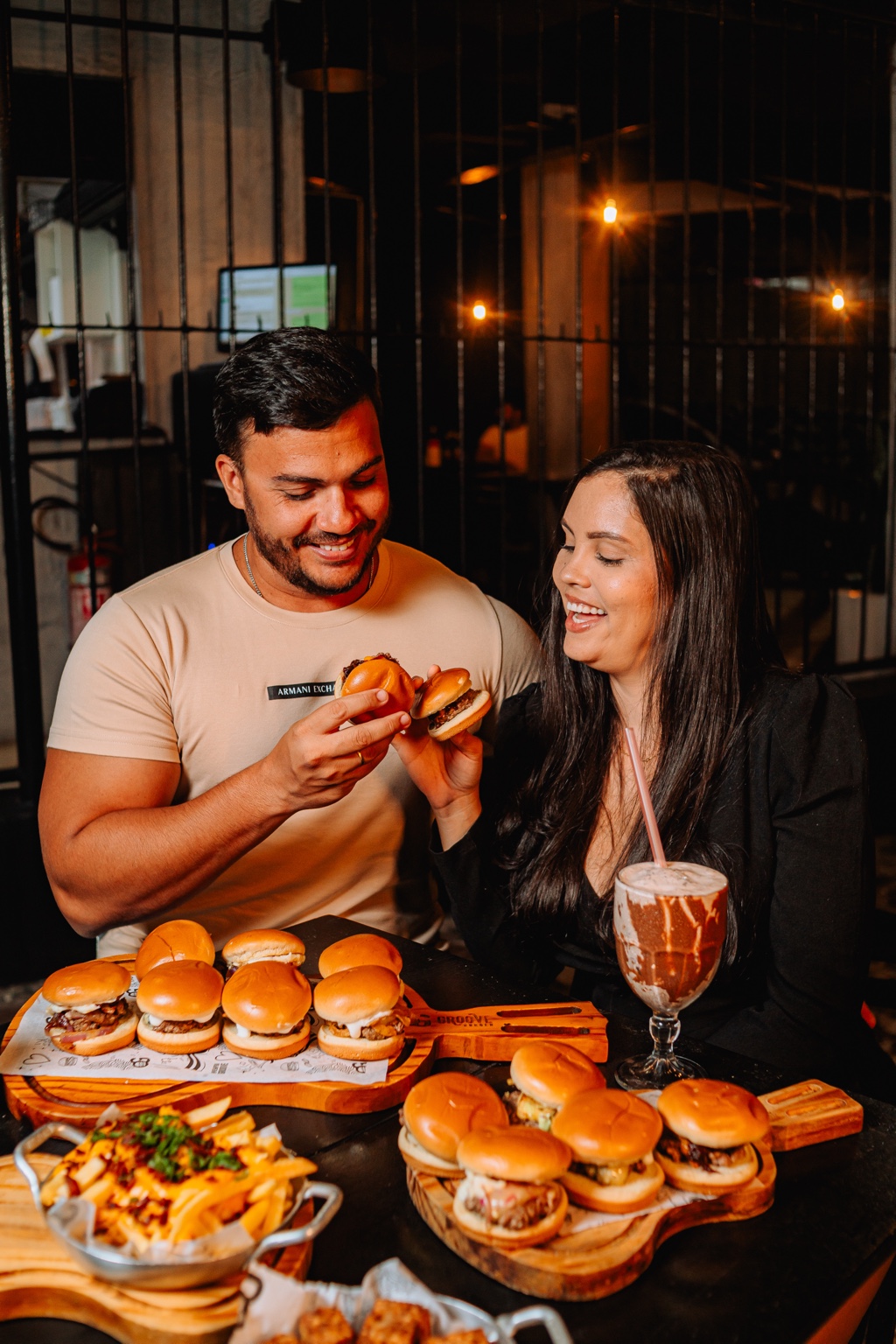 Casal aproveitando mini burgers na Groove Burger